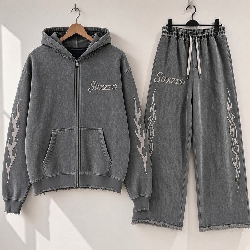 Strxzz Exclusive drop washed charcoal set, hoodie and joggers side by side on a white wall
